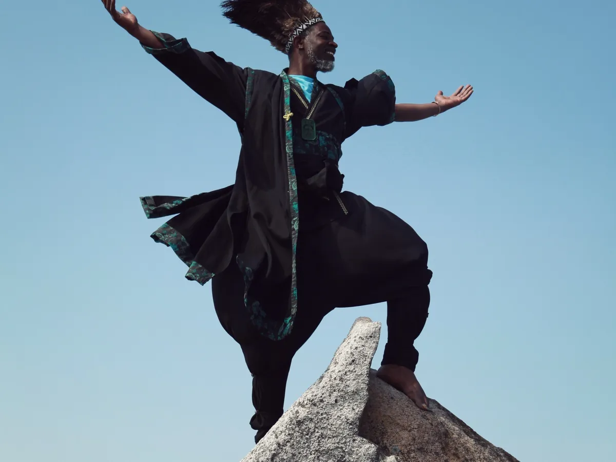 Tura Arutura mid-leap against the sky